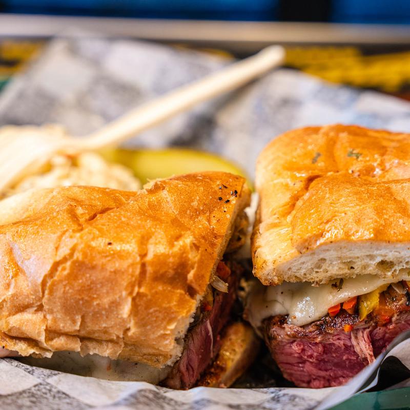 Steak Sandwich, 12 oz. Black Angus strip on a roll with sauteed onions, peppers, mushrooms, and melted provolone